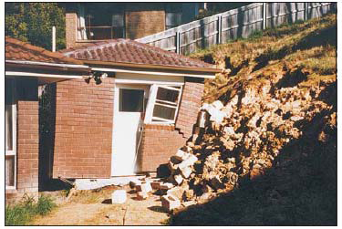 A building pushed off its foundations after a small, shallow slide caused failure of the adjacent retaining wall Source Mineral Resources Tasmania: Landslide Brochure No. 1 – Landslides in Tasmania, 2011 www.mrt.tas.gov.au.