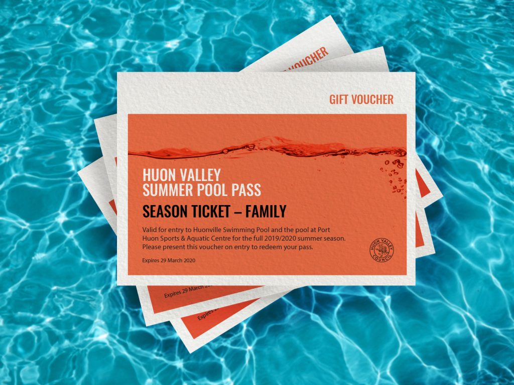 A stack of gift vouchers floats on a clear blue pool. The top voucher reads Huon Valley Summer Pool Pass, Season Ticket - Family, valid for the 2019/2020 summer season. Expiration: March 29, 2020.
