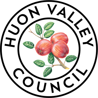 Three red apples with yellow accents and green leaves attached to a brown branch, illustrated in a realistic style on a transparent background.
