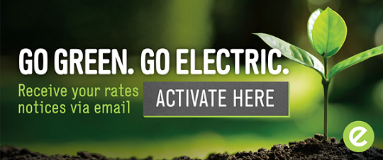 A small green plant grows in soil with sunlight in the background. Text reads, Go Green. Go Electric. Receive your rates notices via email. There is a grey button labeled Activate Here and a green circular logo with an e.